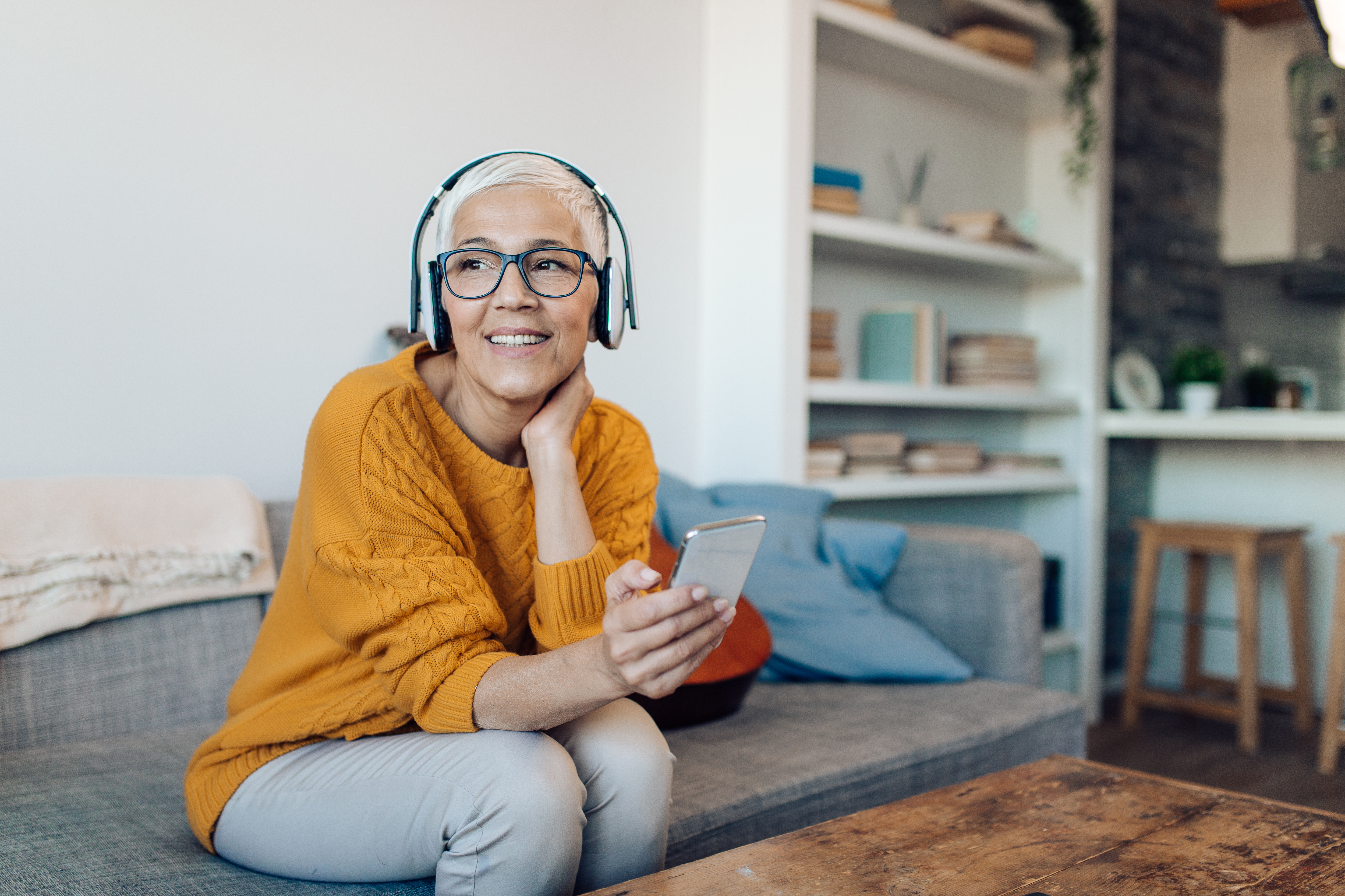 Portrait of a mature woman listening music online